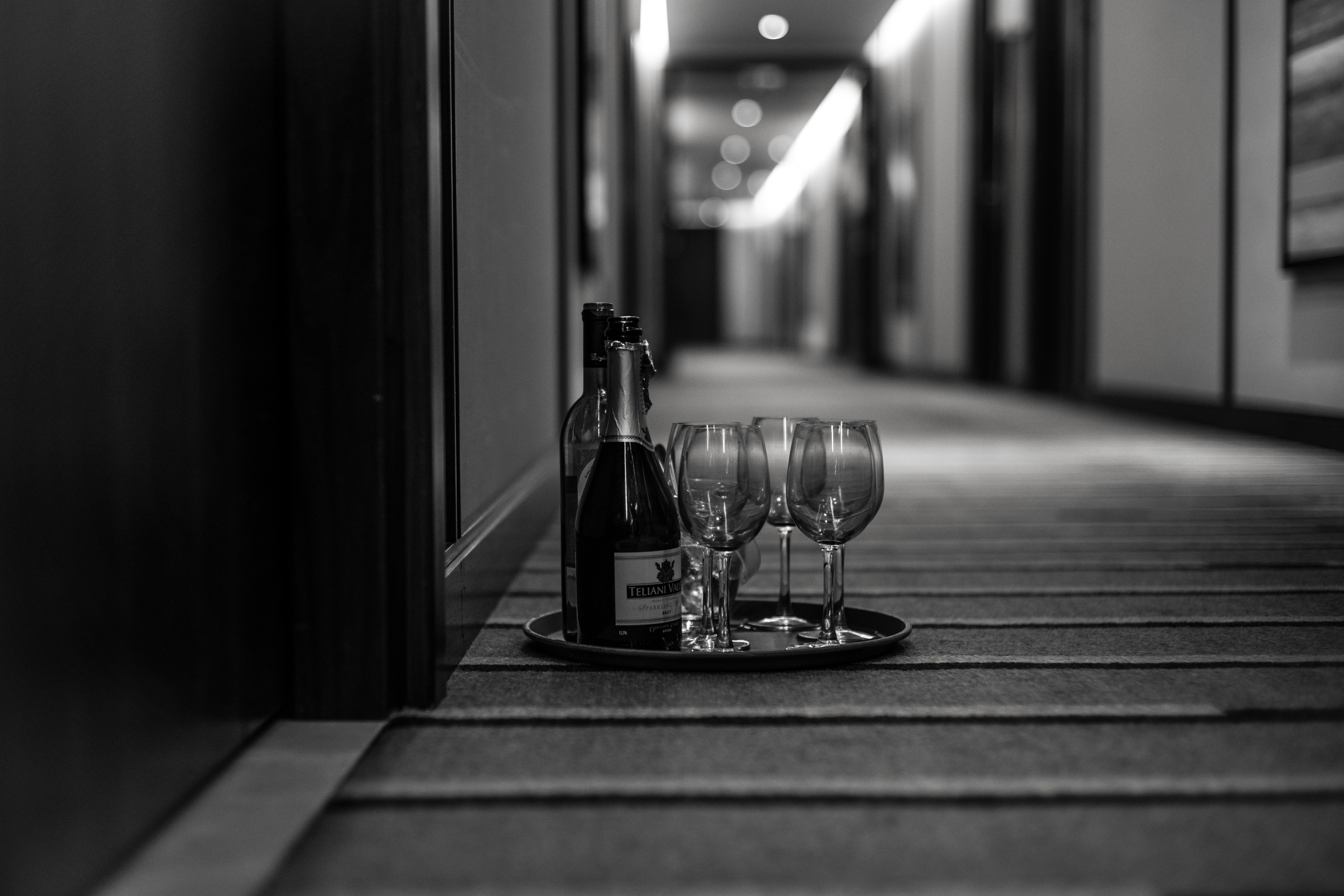 tray with champagne bottle and glasses in front of hotel door